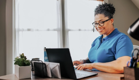 A lady with a headset at her computer