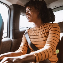 Woman sitting in the backseat of a car