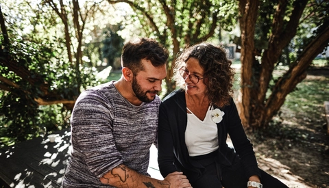 Mother and adult son sitting in garden