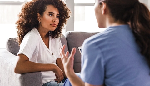 Healthcare provider having a serious conversation with female patient