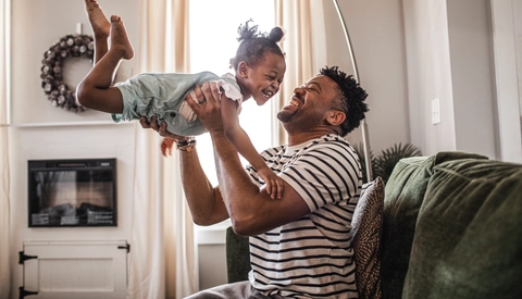 Father playing with toddler daughter
