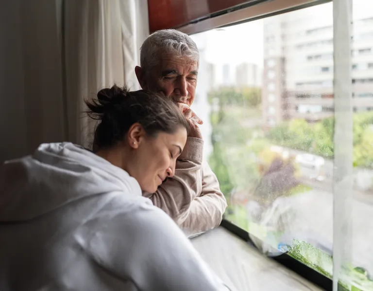 Daughter Embracing Her Senior Father