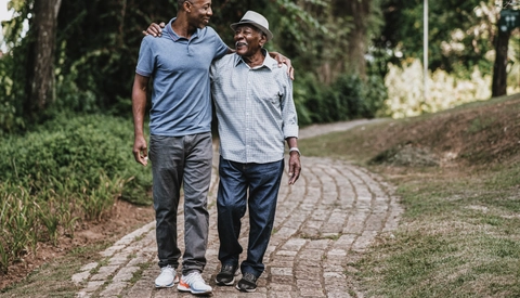 Portrait of elderly father and adult son walking
