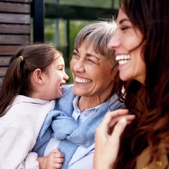 Child, grandmother and mom smiling and interacting