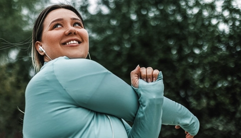 A woman stretching outdoors