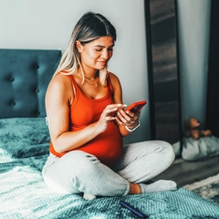Pregnant woman looking at her phone