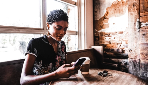 Young woman using smartphone in cafe