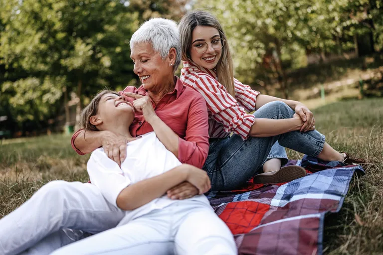 Grandmother having picnic with two granddaughters