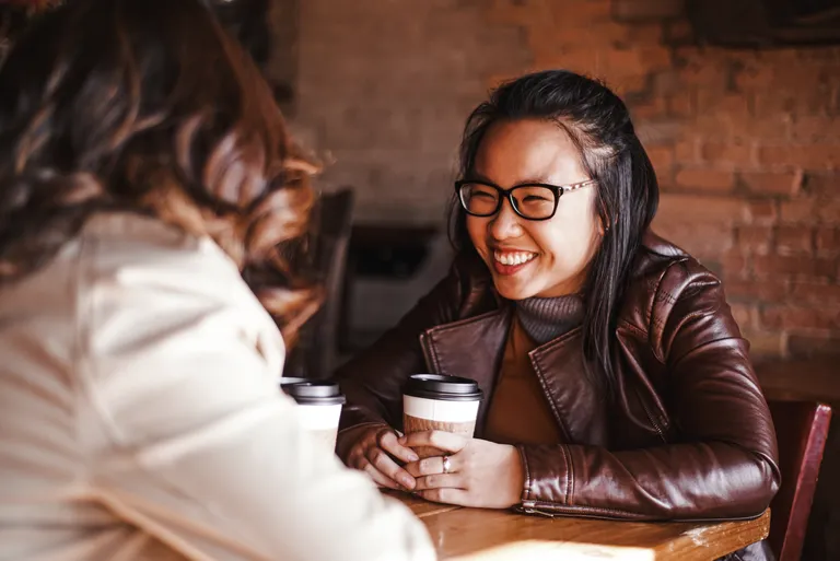 Two girlfriends having coffee at a cafe
