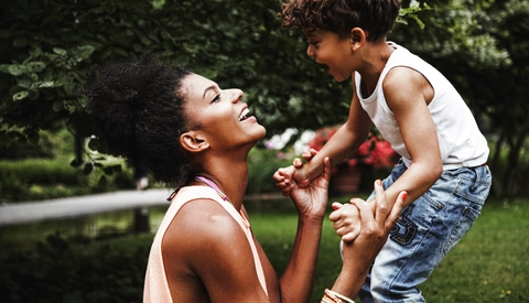 Mother with young son playing in park