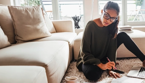 Young woman studying in her living room