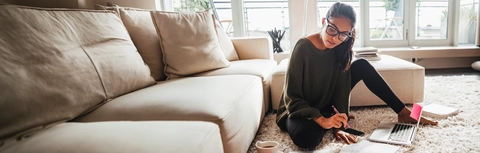 Young woman studying in her living room