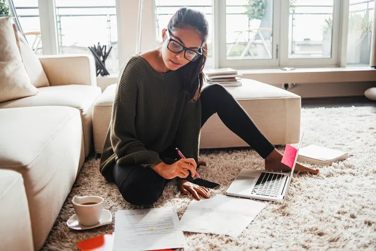 Young woman studying in her living room
