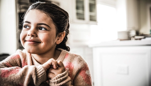 Young girl smiling in kitchen