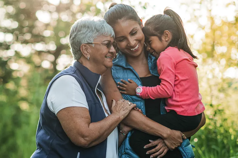 A Hispanic ethnicity family go hiking in the forest at sunset