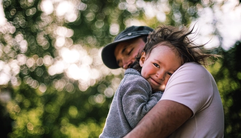 Father holding young son