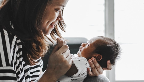 Mother kissing her infant child 