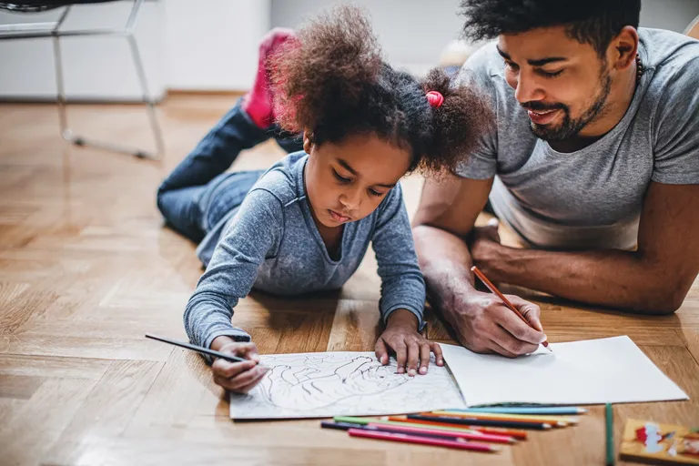 Father and daughter coloring together