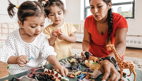 Mother playing with young daughters