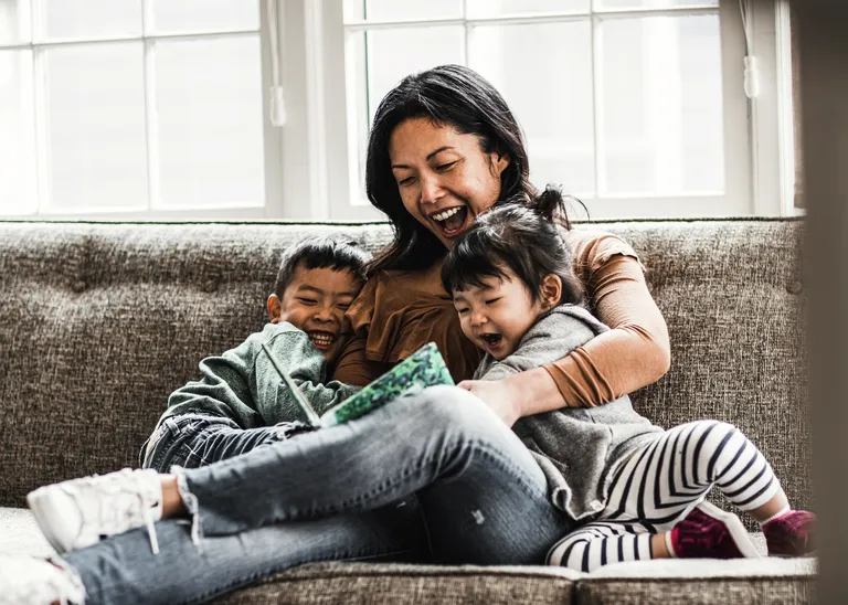 Woman reading to two children