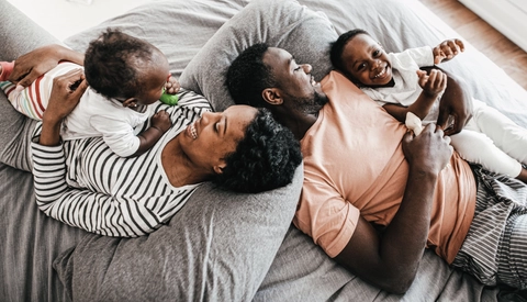 Parents and children laying down smiling