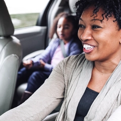 Mother in car with daughter in carseat