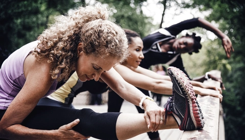 Female friends exercising on bridge