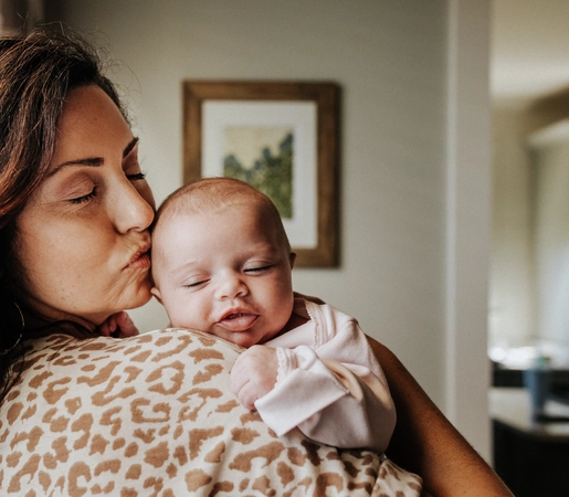 Mother bonding with newborn baby at home