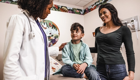 Young patient talking to a doctor at her practice