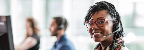 Customer service representative smiling wearing headset