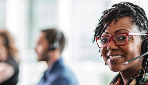Customer service representative smiling wearing headset