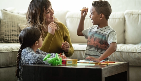 Young Mother of Two Playing in the Living Room