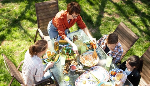 Overhead view of family at table eating meal outdoors