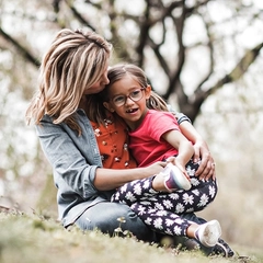 A mother and her 7 year old daughter at a park. a