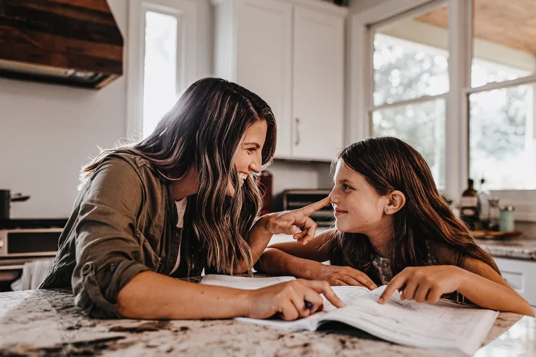 Mother and young daughter in kitchen