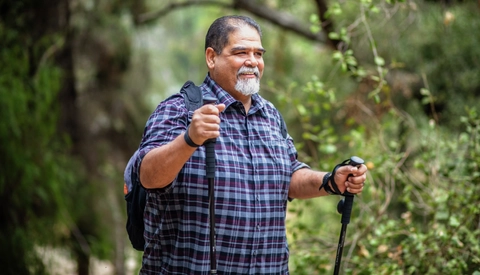 Older man happily hiking in nature