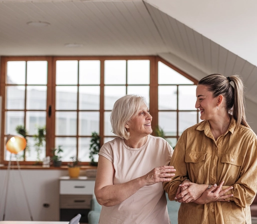 Mature woman walking arm-in-arm with adult female