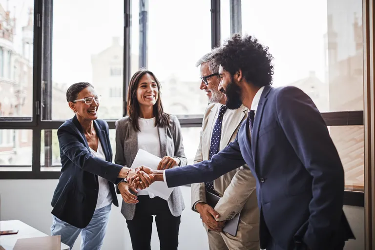 Group of business people greeting one another