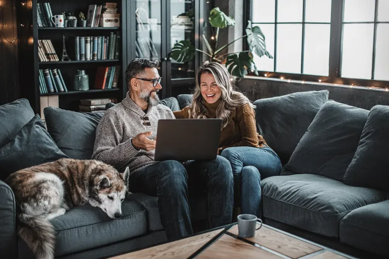 Couple at home using video call to talk with friends or family