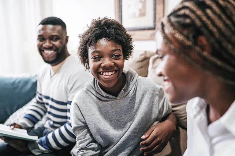 Family enjoy time together sitting on the sofa