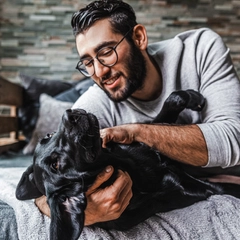 Smiling man petting his dog