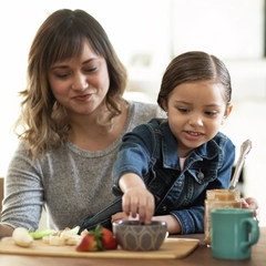 Mom and her young daughter make a healthy snack