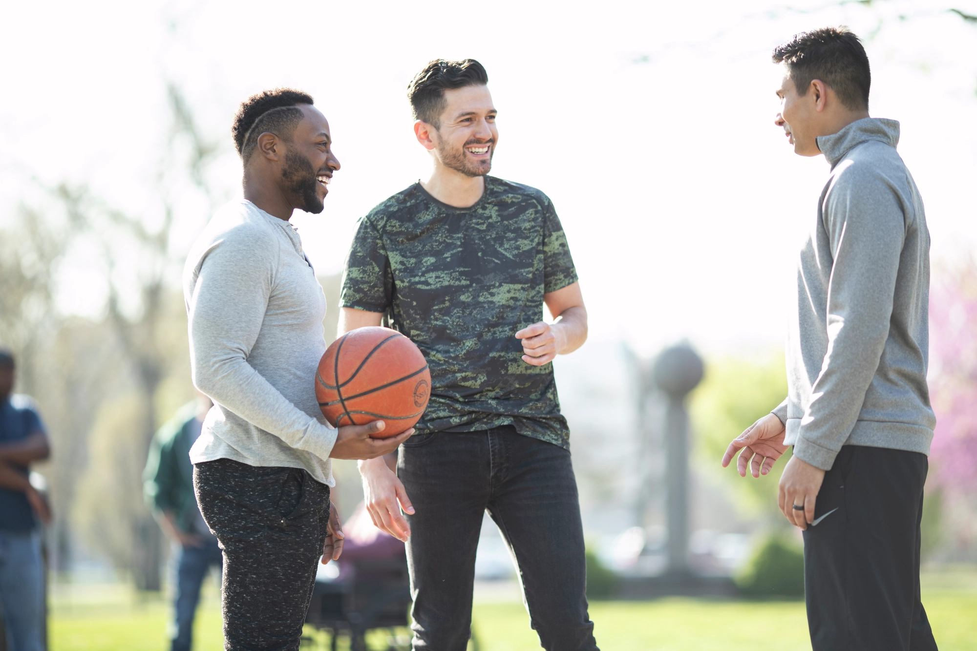 A group of friends socializes during a basketball game break