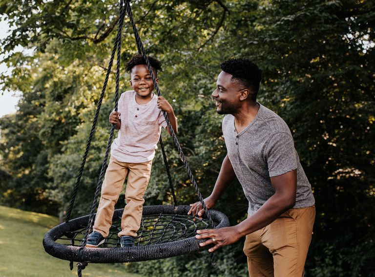 Happy father and son playing in backyard