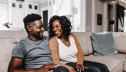 Happy couple sitting on couch