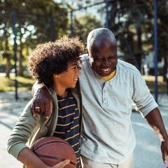 Grandfather playing basketball with his grandson