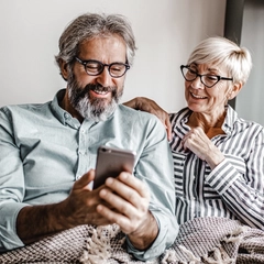 Seniors at home using smart phone