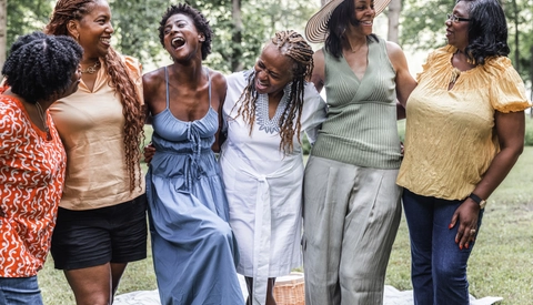 Group of Women Gather with Friends for Picnic Luncheon Outdoors