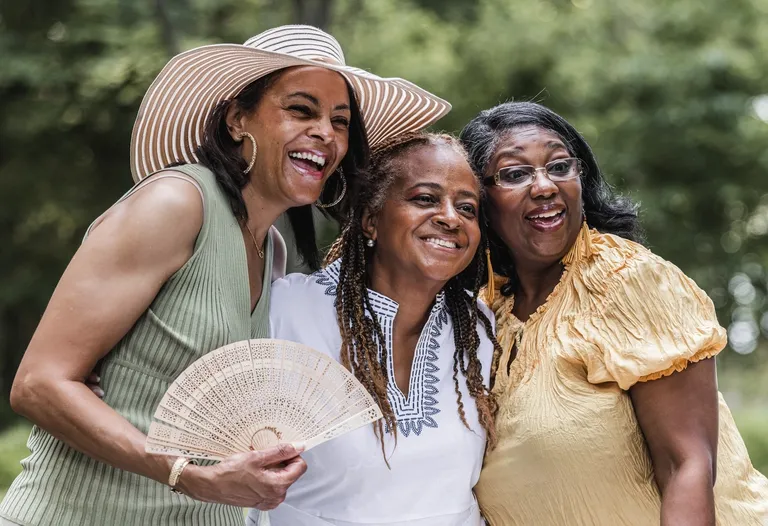 Group of African American Women Gather with Friends for Picnic Luncheon Outdoors