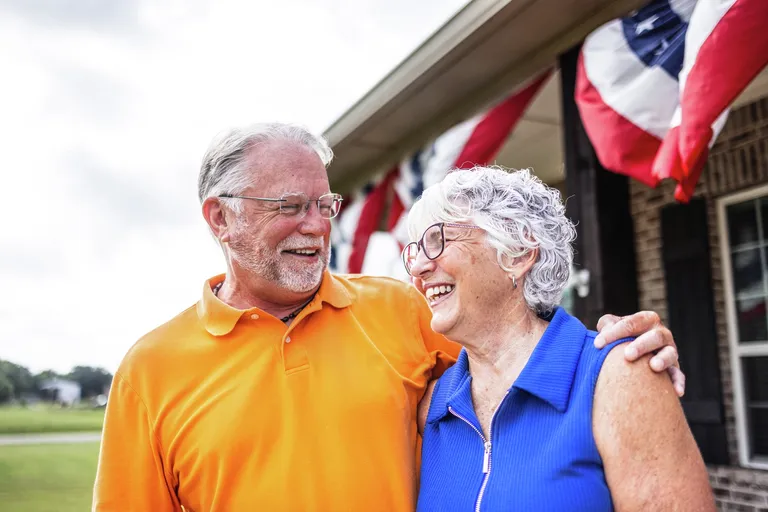 Senior couple outside home
